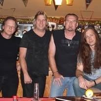 Four band members together at a bar