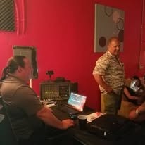 Two band members at the mixing desk in the studio