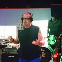 Singer in headphones tracking vocals in the studio